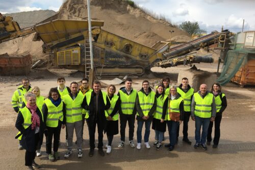 Group picture in front of a crusher
