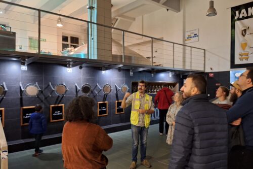 a man talks to people in a brewery