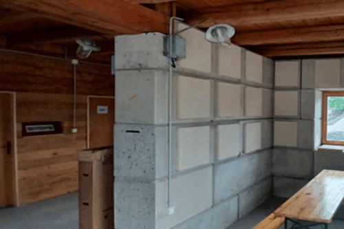 a room with hemp acoustic panels, a wooden table and a window