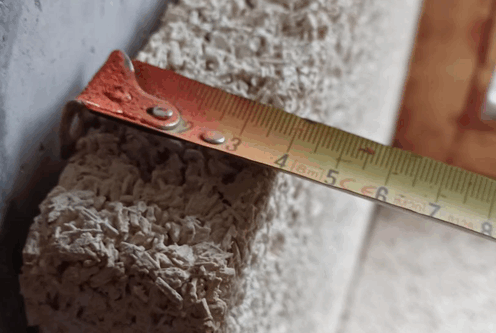 measuring tape on hempcrete
