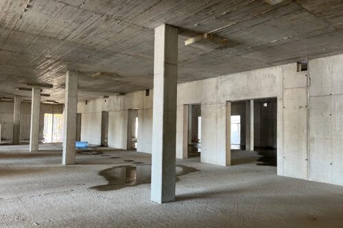 concrete pillars and walls inside a unfinished building