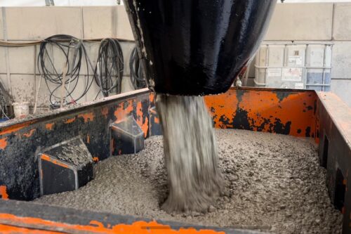 concrete beeing filled in a steel mould