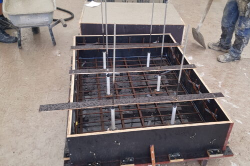 several moulds for concrete, some of which are filled